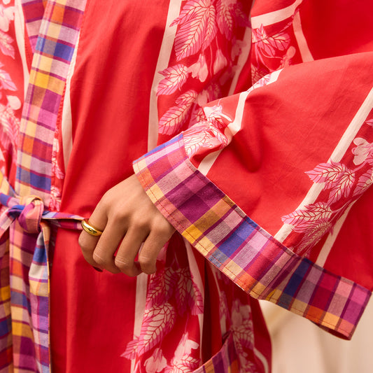 Red garment with colorful plaid accents and floral patterns