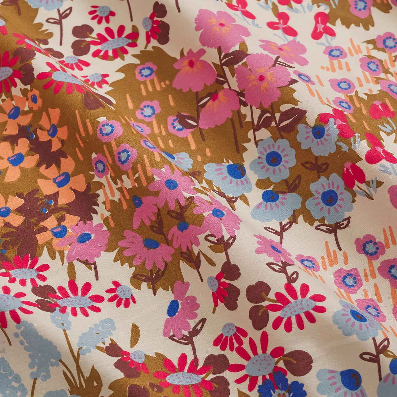 Colorful floral patterned fabric with pink, blue, and brown flowers.