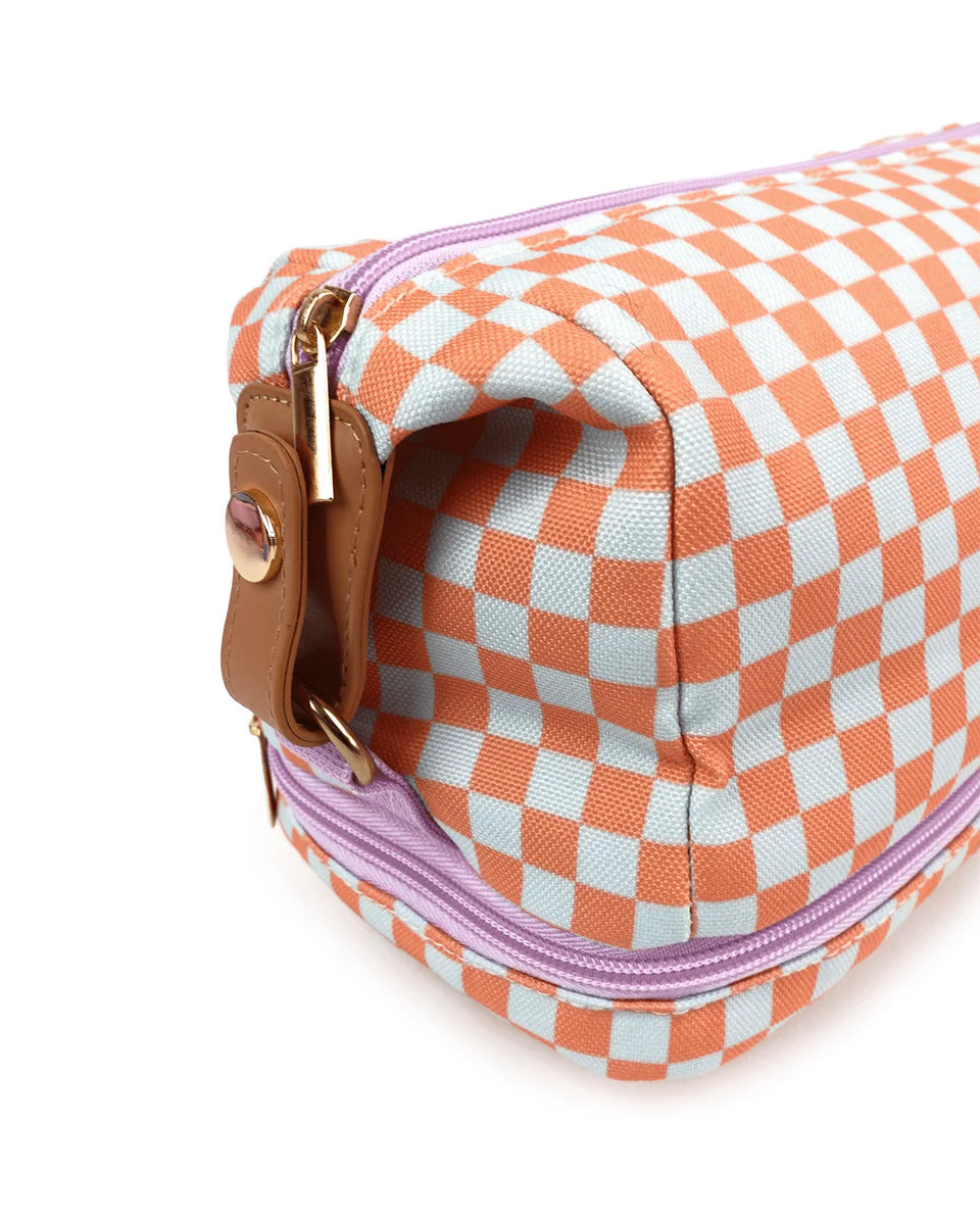 Gingham orange and white pattern, lilac zip across top and around base, leather side strap detail. Gold zip handle.