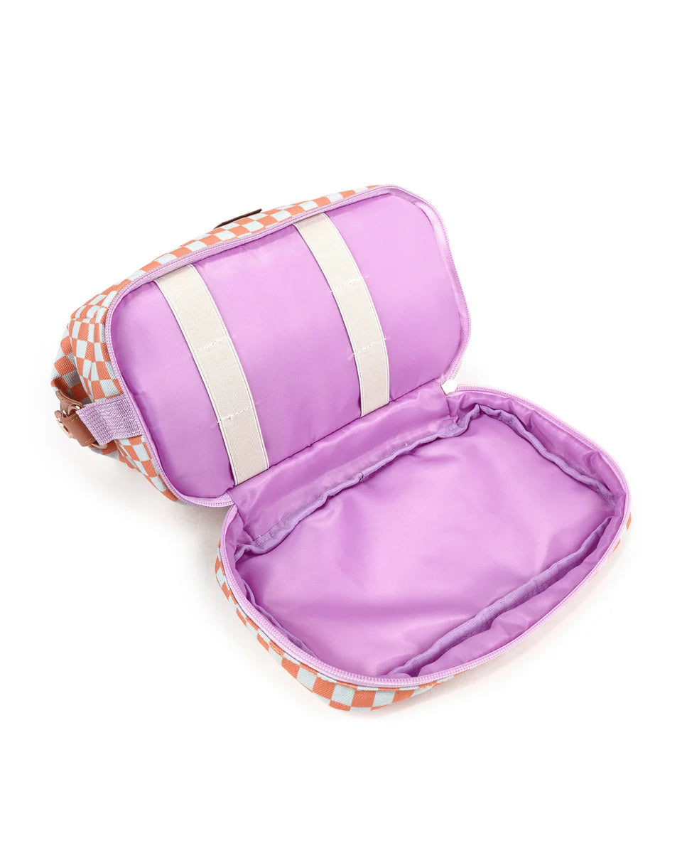 Shows open base of cosmetic bag, with two elastic straps on one side and empty bottom of bag for cosmetics to go. Zip around base open.