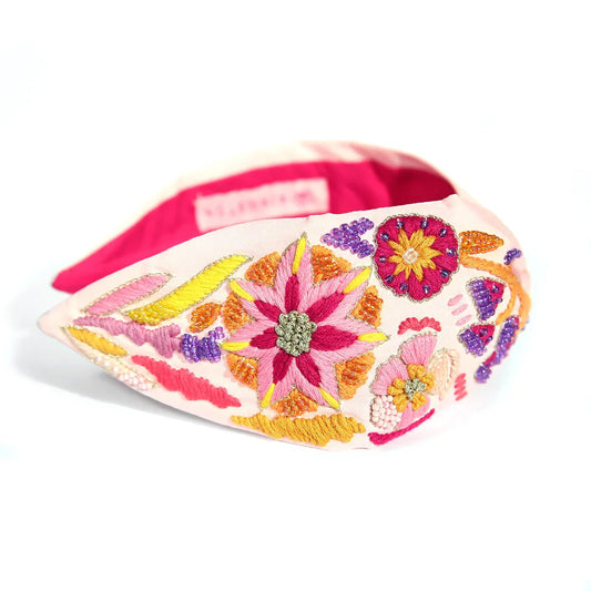 Pink base headband with embroidery detail, beaded detail and various pink flower size and details.