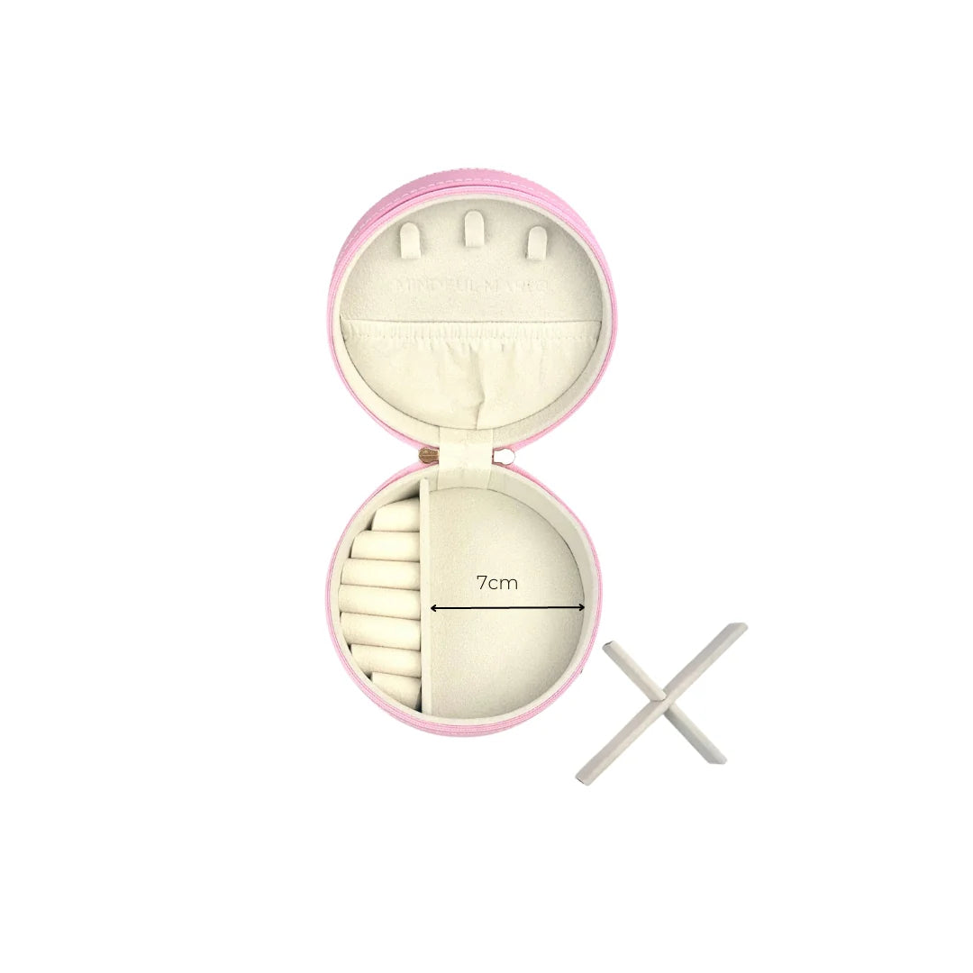 Round pink case open showing area for rings or earrings to stick in, pouch and showing measurement '7cm' for empty side.