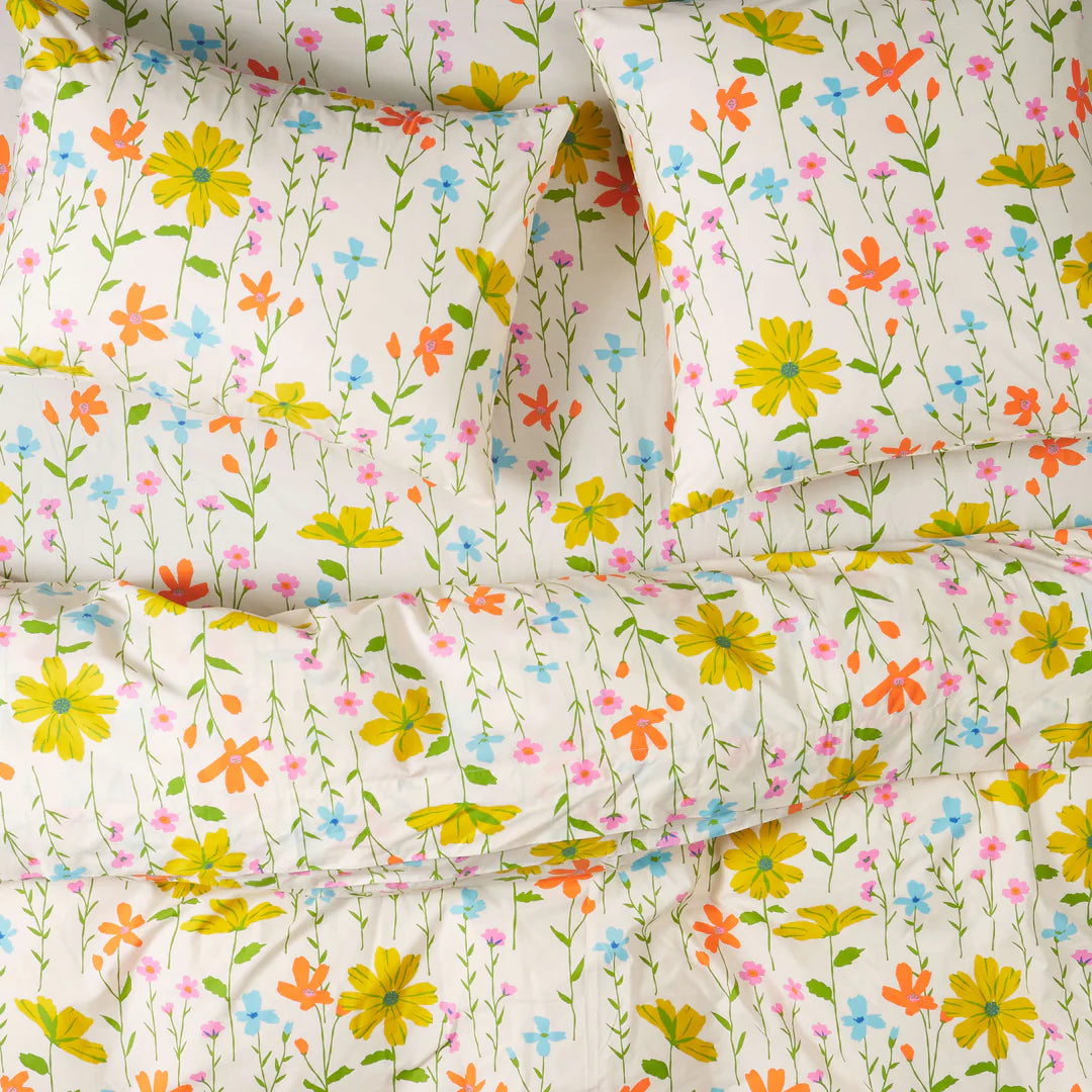 Floral patterned bedding set with colorful flowers on a white background