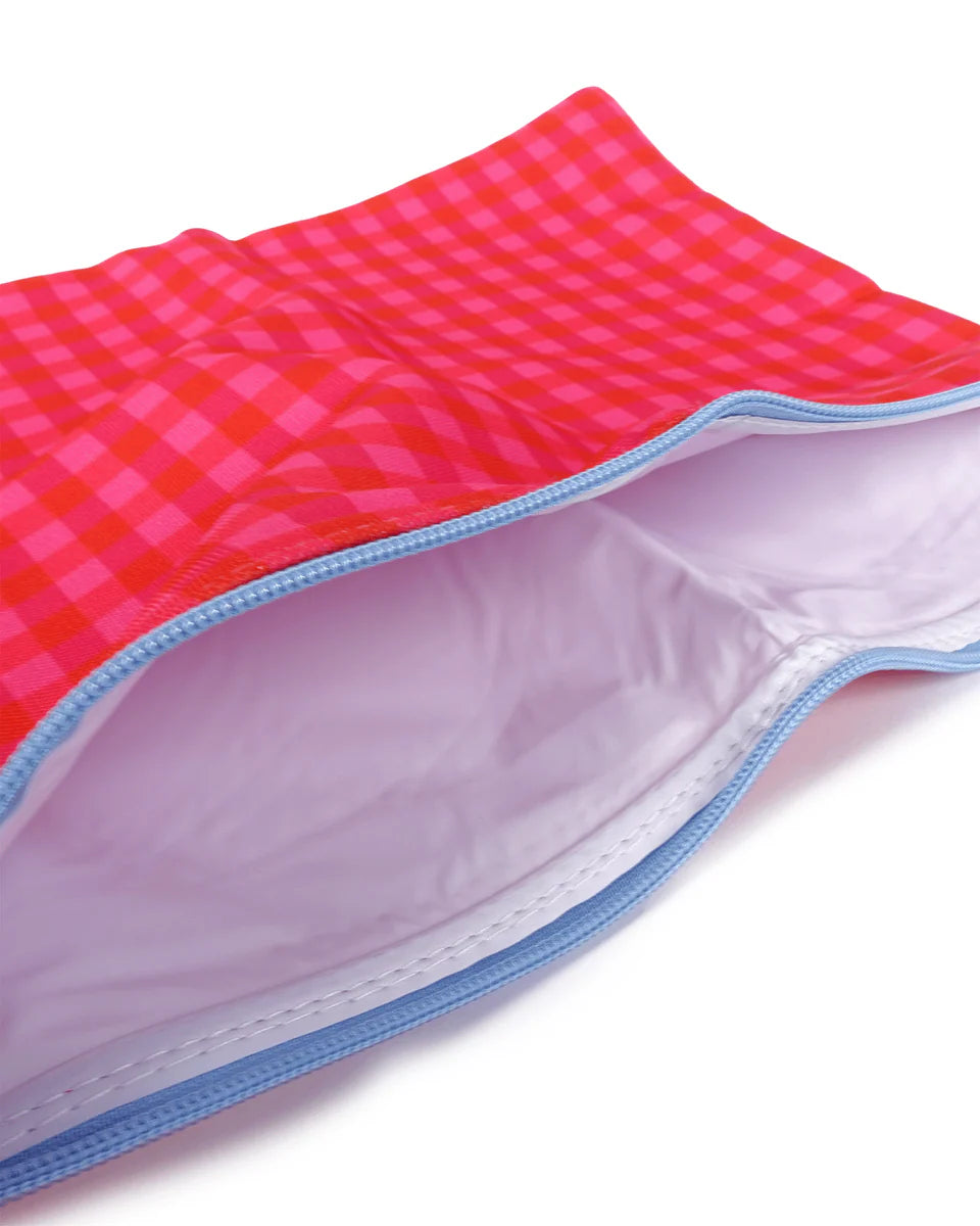 Close-up of a pink and blue checkered fabric with a white background