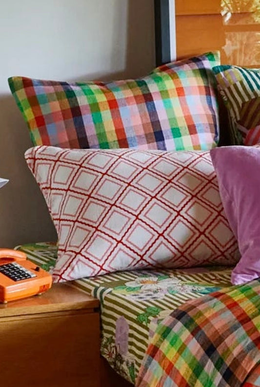 Colorful pillows close up on bed styled shot.