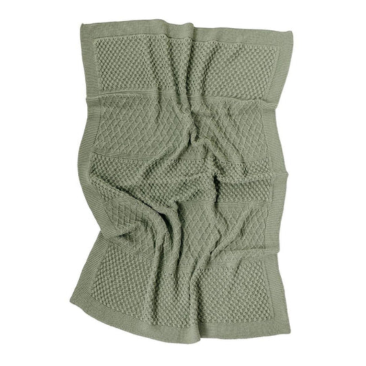 Green knitted blanket with a textured pattern on a white background