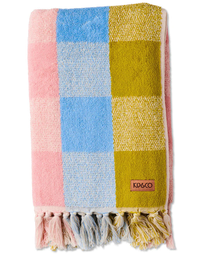 Colorful checkered towel with tassels and a brand logo on a white background