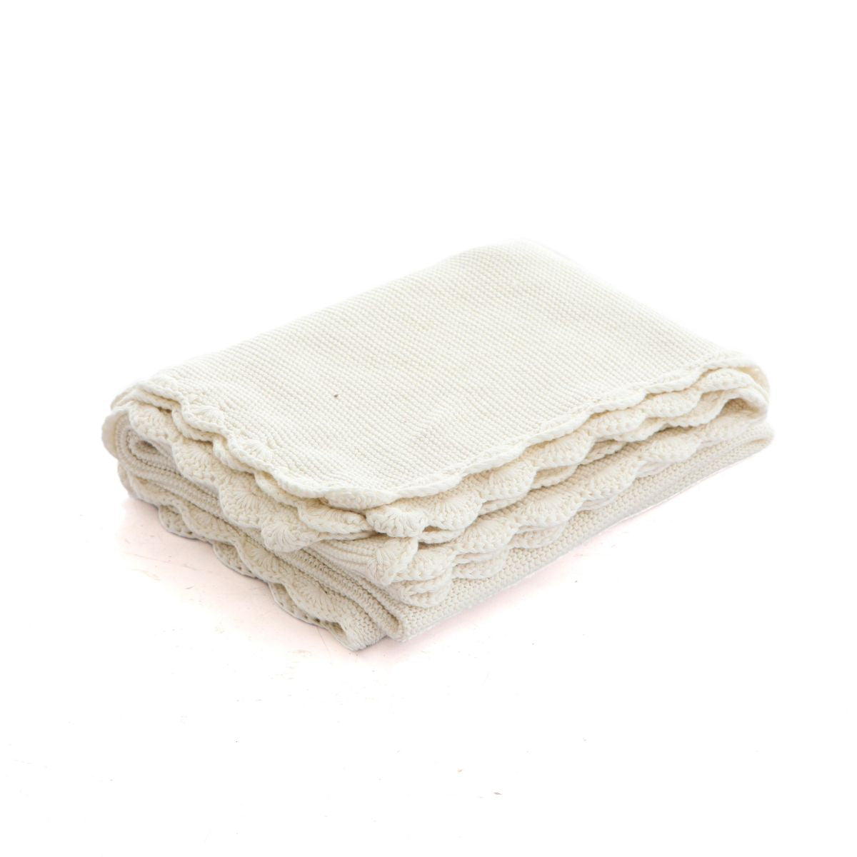 Folded beige blanket on a white background