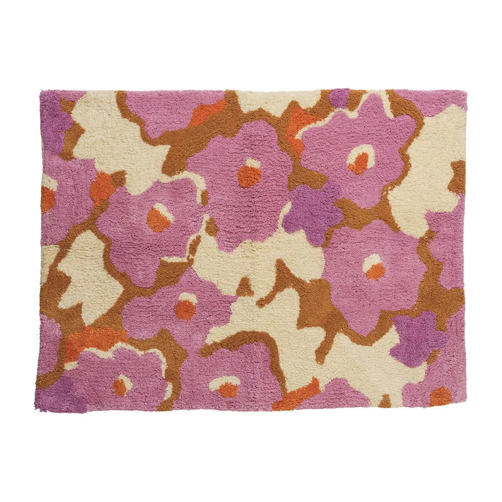 Floral patterned rug with pink, brown, and beige colors on a white background