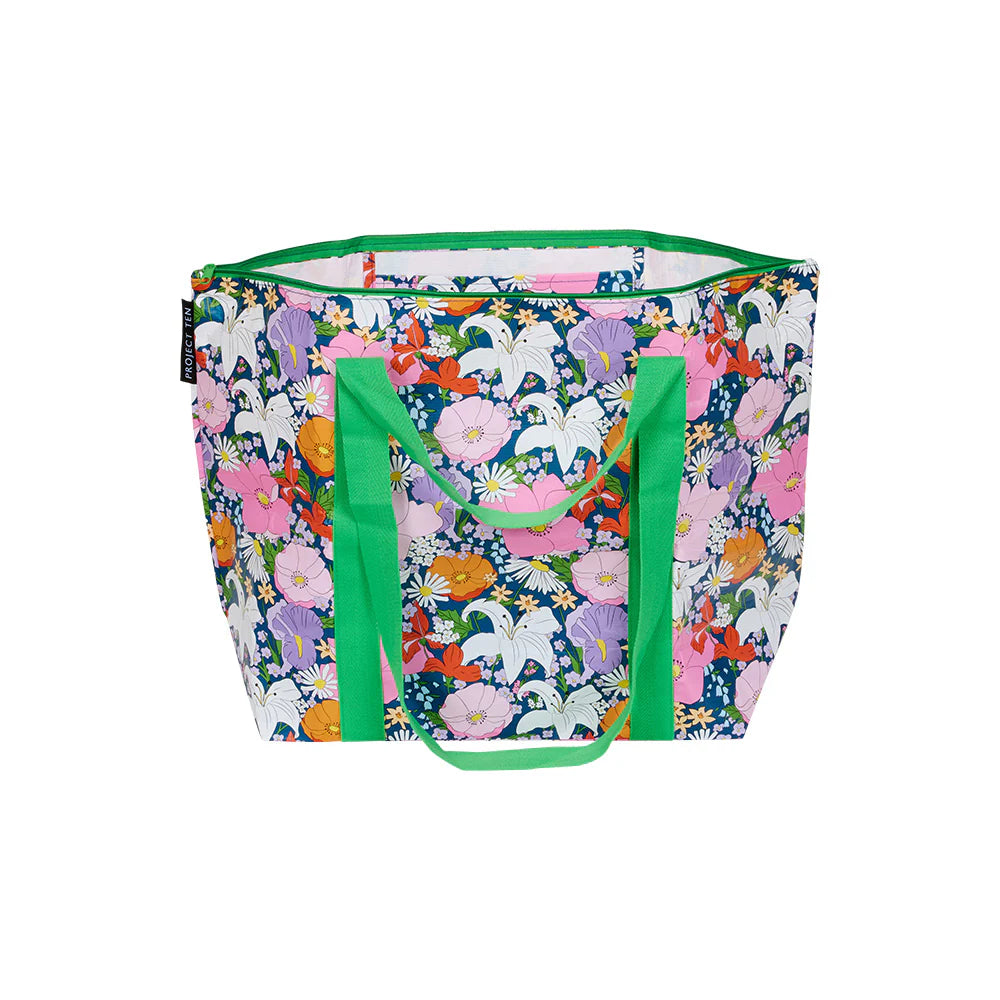 Floral-patterned tote bag with green handles on a white background