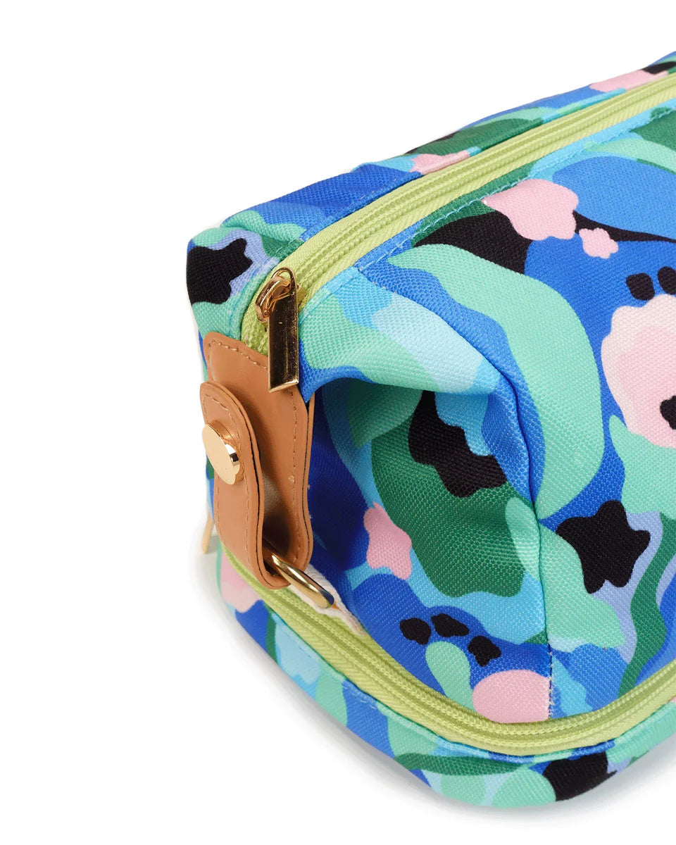 Close up of leather and zip detail, green zip. Blue and green with small black and pink details.
