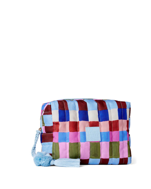 Multicolored checkered pouch with a blue tassel on a white background