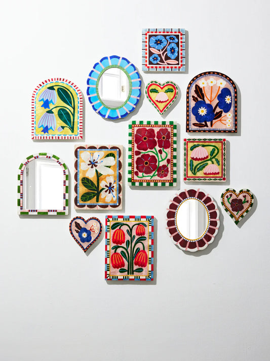 Collection of colorful decorative wall mirrors on a white background