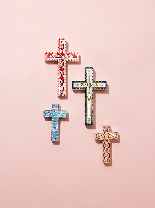 Decorative crosses with intricate patterns on a pink background