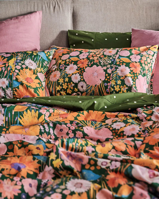 Floral patterned bedding with pink and green accents.