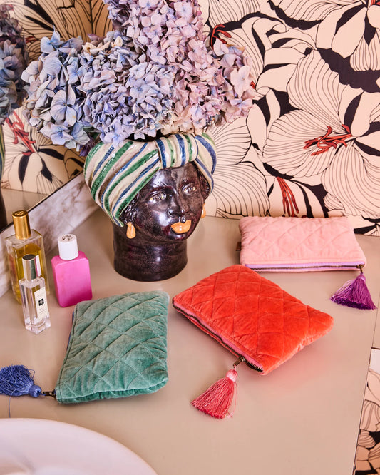 Colorful bags and a decorative head with a turban on a patterned surface
