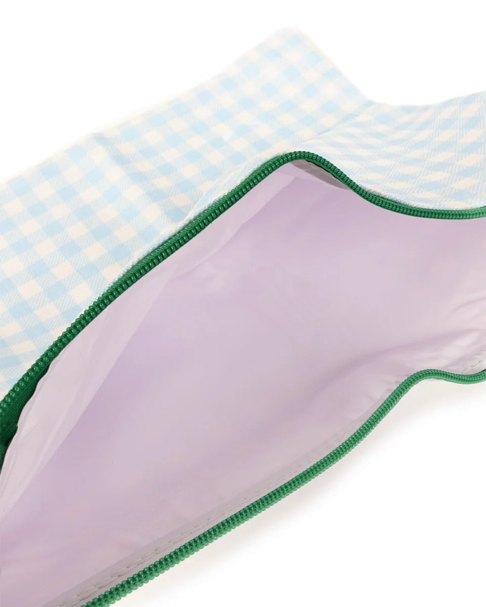 Close-up of a fabric with green border on a checkered background