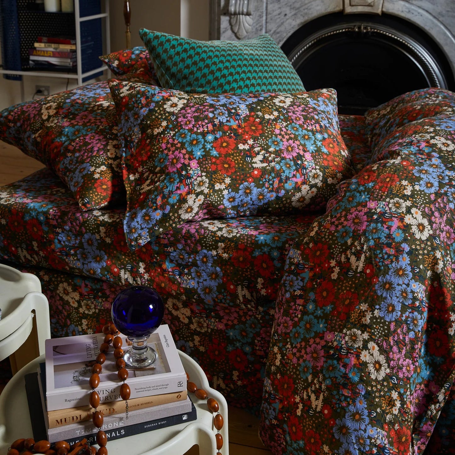 Floral-patterned sofa and cushions in a cozy room.