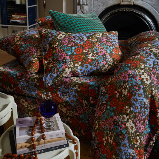 Floral-patterned sofa and cushions in a cozy room.