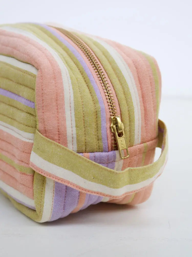 Pastel striped pouch with a gold zipper on a white background