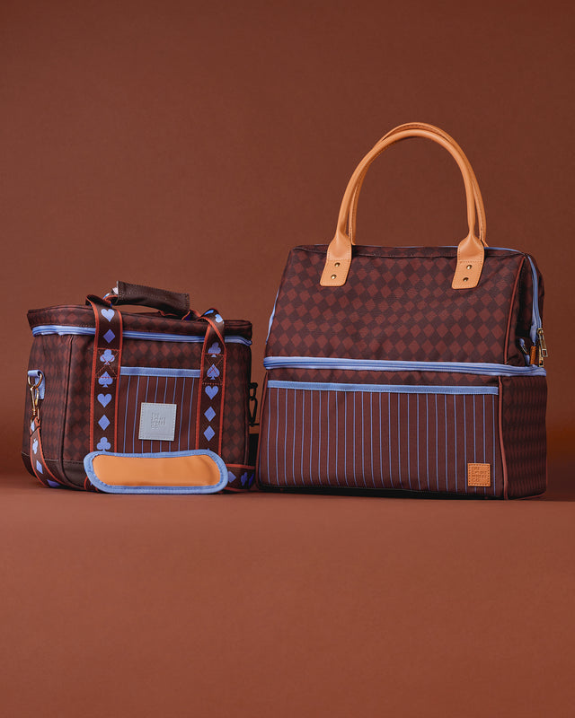Two brown patterned bags with leather handles on a brown background