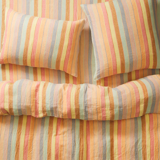Striped pastel bedding with multicolor pattern on a bed, matching euro pillowcase, sheet and doona cover,