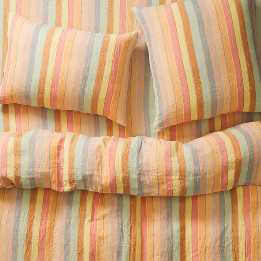 Colorful striped bedding with pillows on a bed