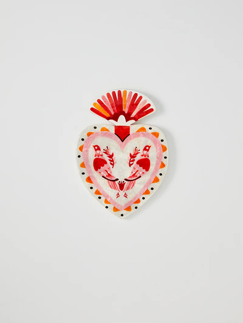 Decorative heart-shaped object with red and orange design on a white background