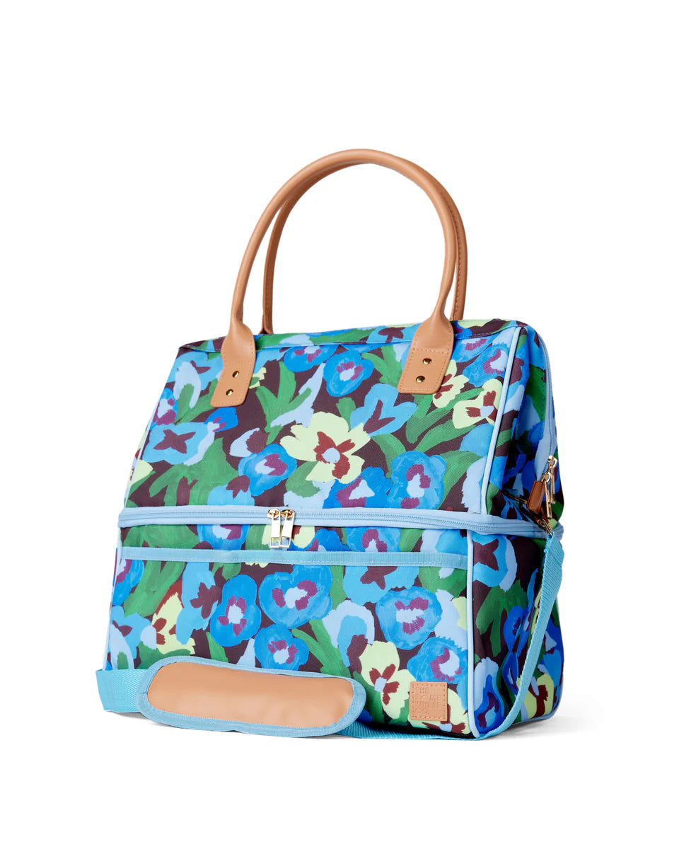 Green, blue, yellow floral pattern cooler bag on white background.