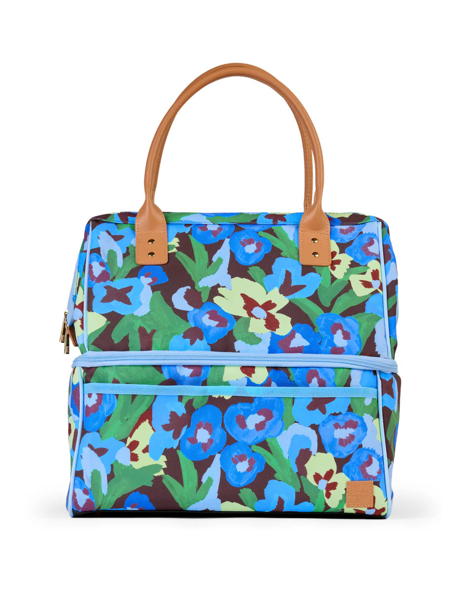 Floral patterned handbag with brown handle on a white background