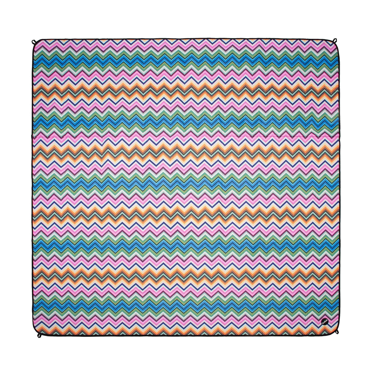 A square textile product, likely a throw blanket or pillow cover, featuring a vibrant multicolor chevron pattern with horizontal stripes of pink, blue, orange, and white zigzags, finished with black piping along the edges.
