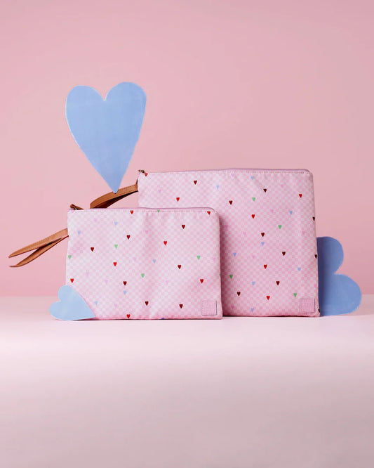 Pink pouches with heart pattern on a pink background