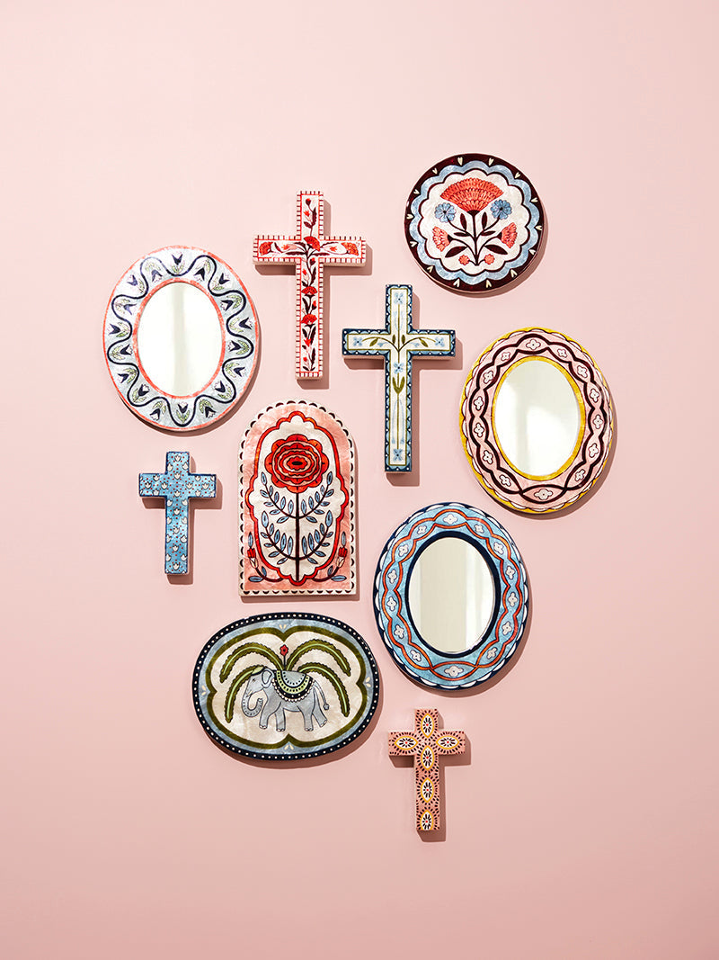 Decorative wall plates with various designs on a pink background