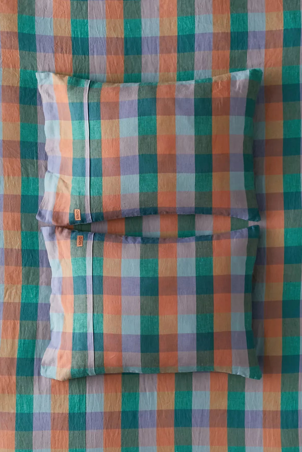 Checkered fabric with a pattern of green, orange, and purple squares.