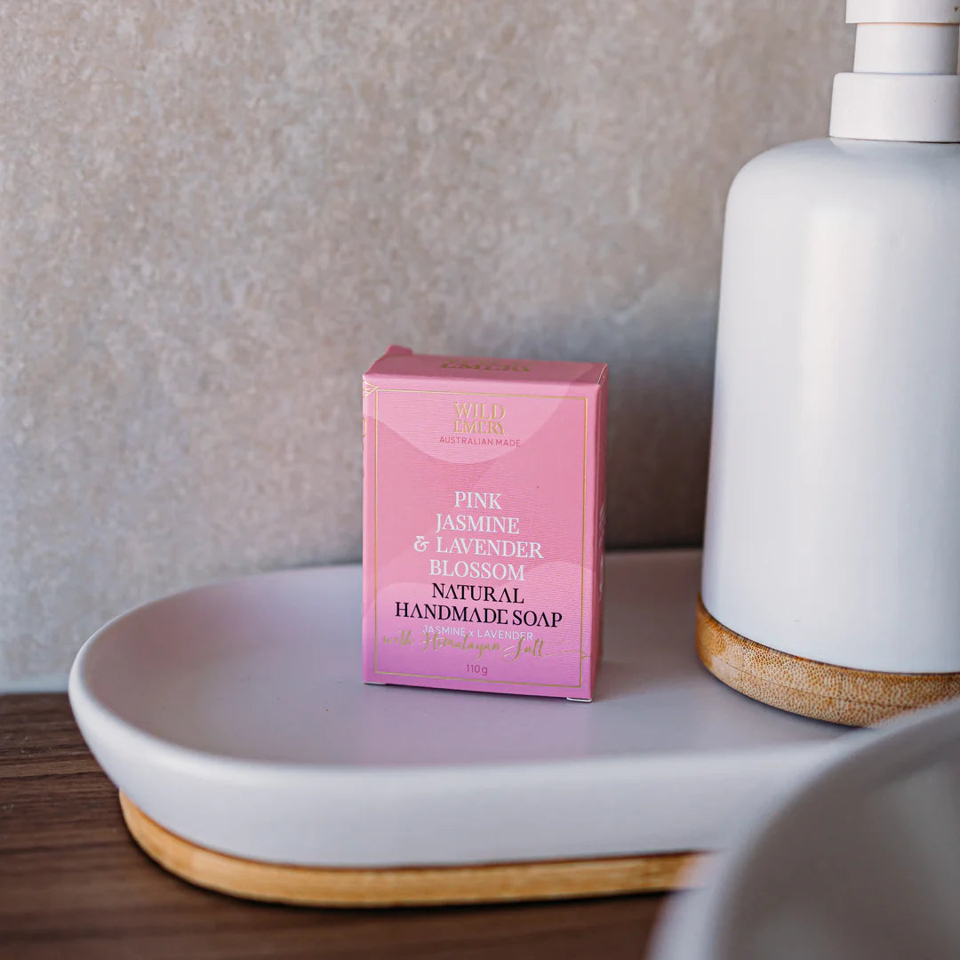 Pink box of natural handmade soap on a white surface with a neutral background. Scent Pink Jasmine, and Lavender Blossom.