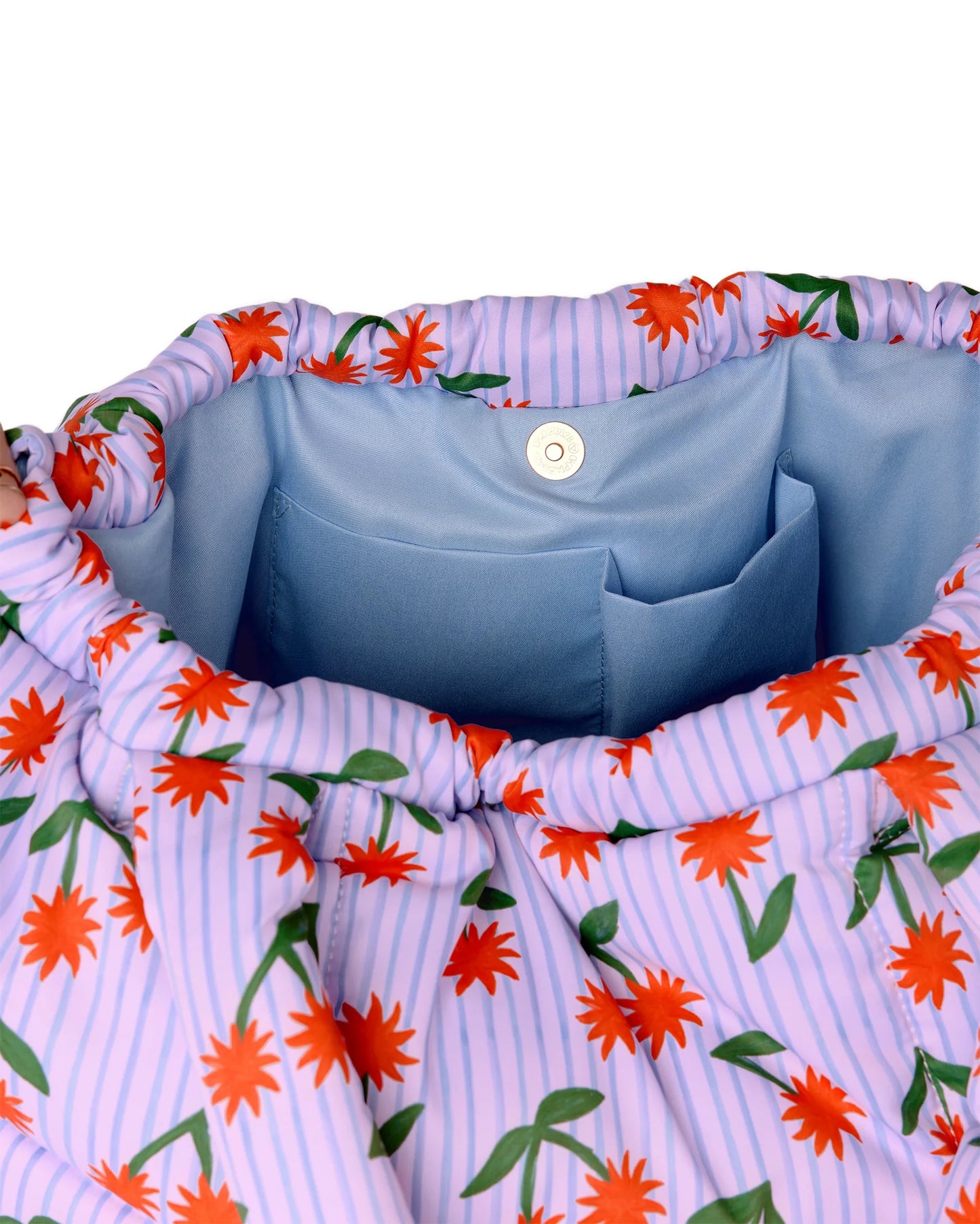 Floral-patterned fabric with a blue interior pocket on a white background