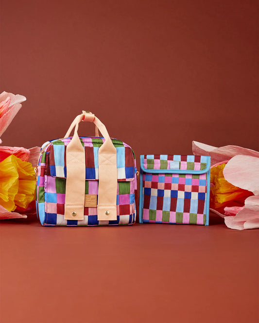 Colorful checkered bags with leather straps on a brown background