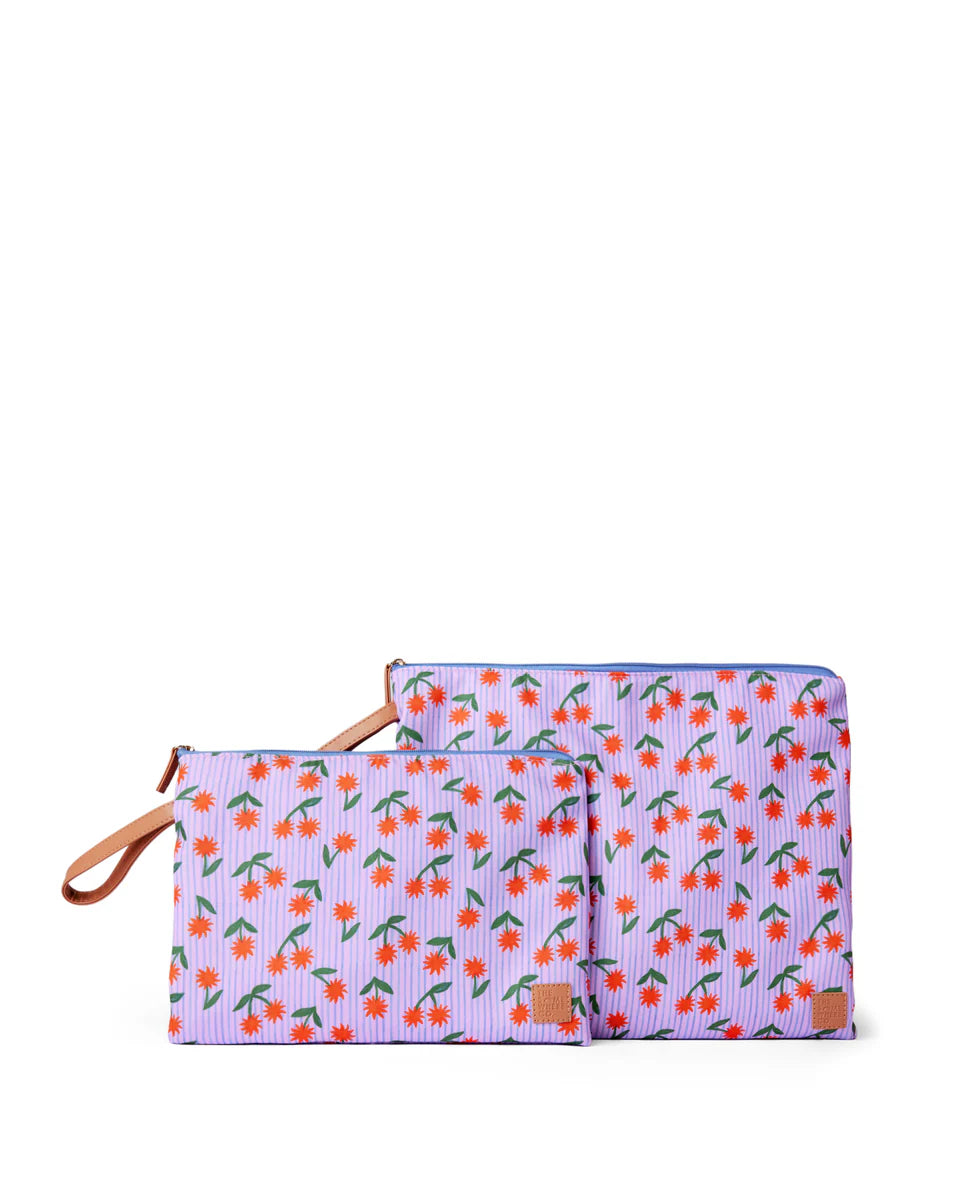 Two purple pouches with cherry pattern on a white background