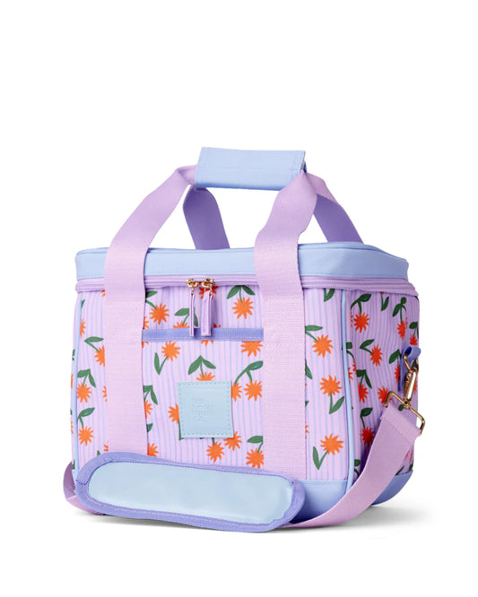 Floral-patterned cooler bag with purple handles and base on a white background