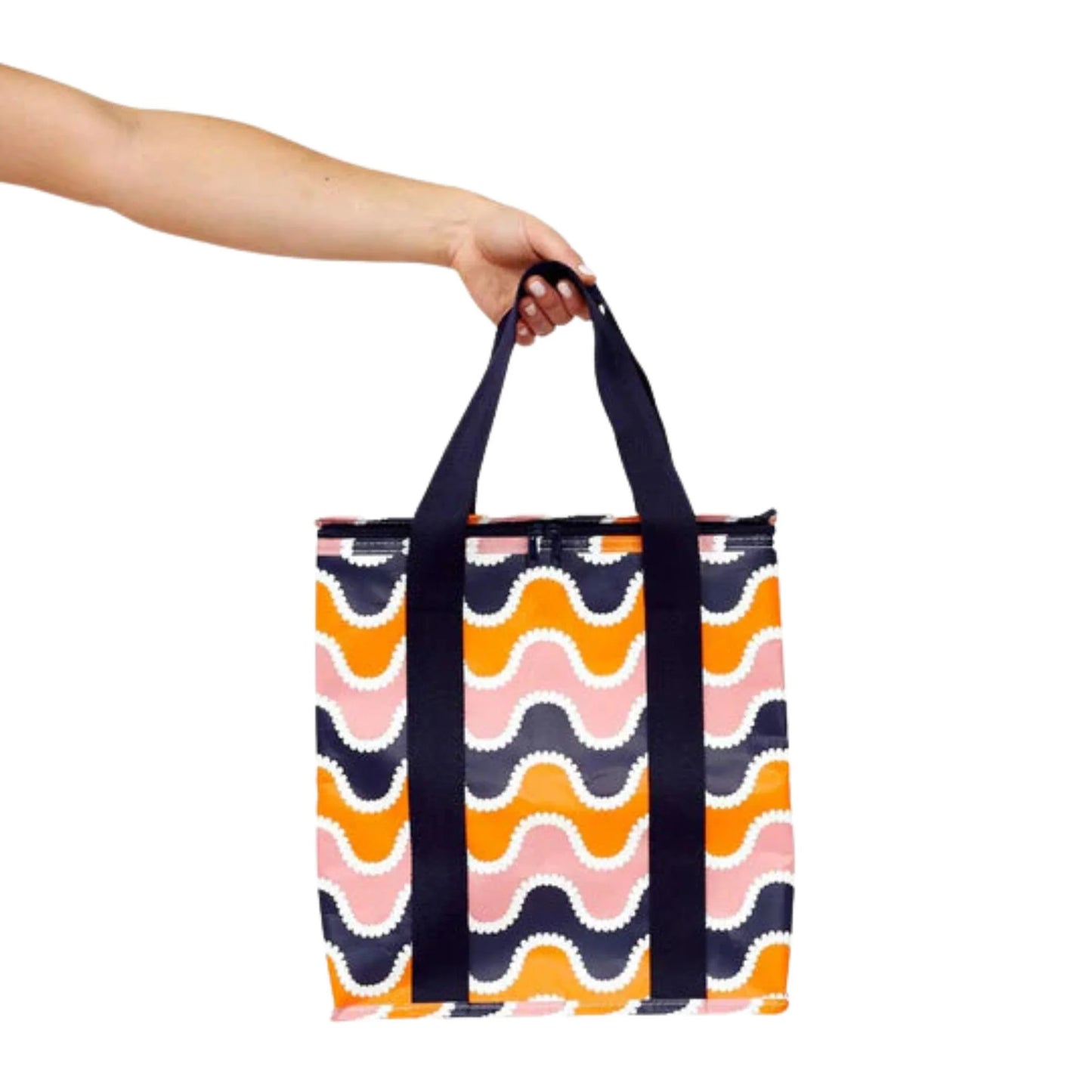 Colorful wavy-patterned tote bag held by a hand on a white background