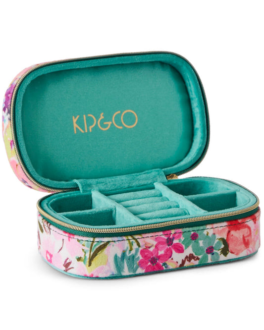 An open KIP&CO jewelry organizer case with a pink floral exterior and a teal velvet interior, featuring a ring roll and zippered closure.