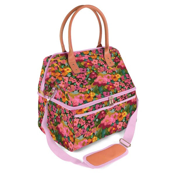Floral patterned handbag with pink accents on a white background