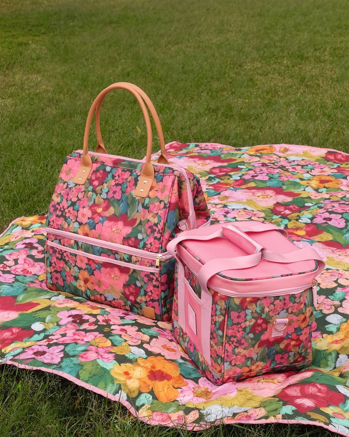 Floral-patterned bags on a matching floral blanket outdoors