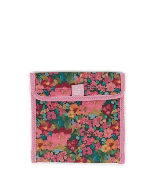 Snach bag with green base and assorted pink, greens, red and orange flowers. Pink edging and somewhere co label sewn into edging at front. 