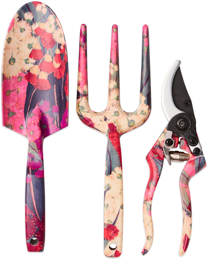 A three-piece garden tool set including a trowel, a three-tined garden fork, and pruning shears, all featuring a vibrant floral pattern in pink, red, and cream on a white background.
