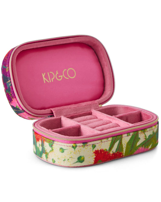 An open Kip&co travel jewelry case with a pink velvet interior and a floral printed exterior, shown on a white background.