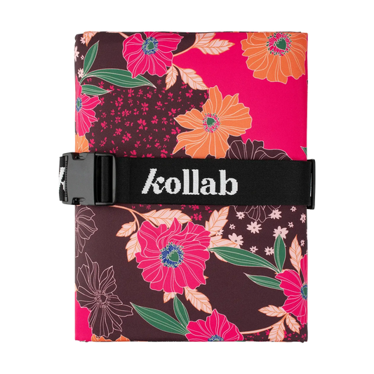 Floral-patterned picnic mat folded with 'kollab' branding on a white background