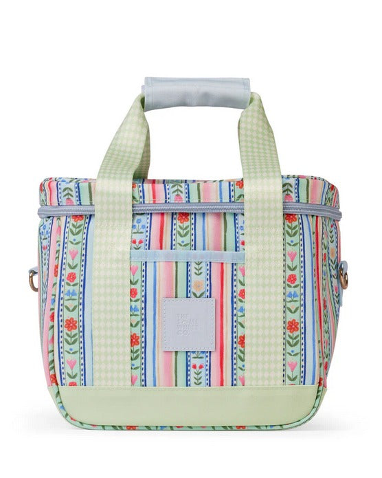 Colorful patterned bag with floral and striped design on a white background