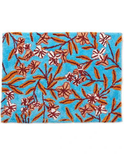 Floral-patterned rug with brown and pink flowers on a blue background