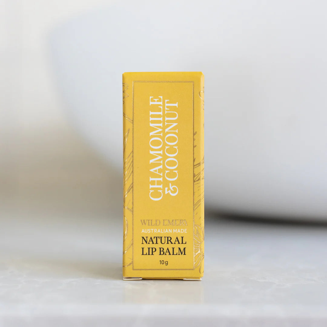 Yellow box of Chamomile & Coconut lip balm on a white background
